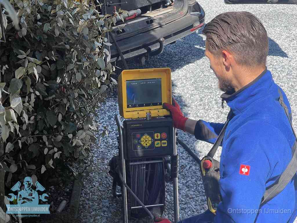 Monteur bedient een rioolinspectiecamera met monitor voor rioolinspectie in IJmuiden
